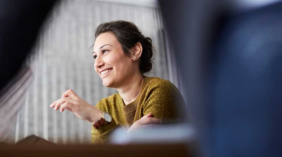 Smiling businesswoman sitting in front of female colleague at creative office