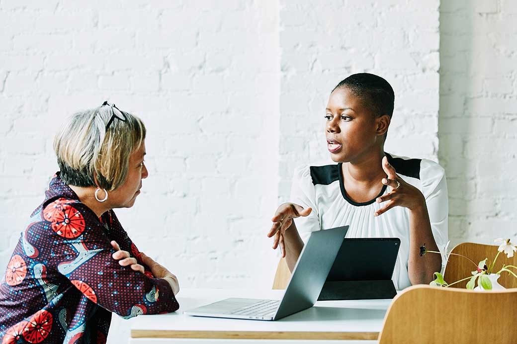 Female financial advisor in discussion with client in office conference room